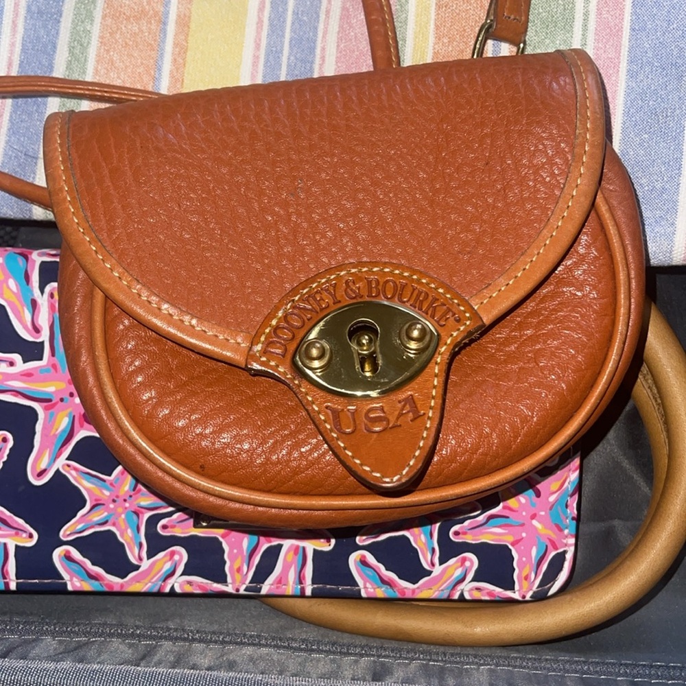 Dooney and Bourke Calvary crossbody/belt purse.  All weather leather with brass